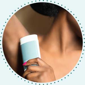 woman putting on best natural deodorant