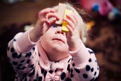 baby with wooden toy