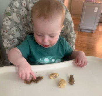 baby playing with Yumi food