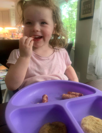 toddler eating yumi review beet puffs