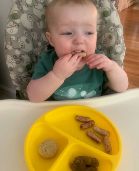 baby eating Yumi food review puffs