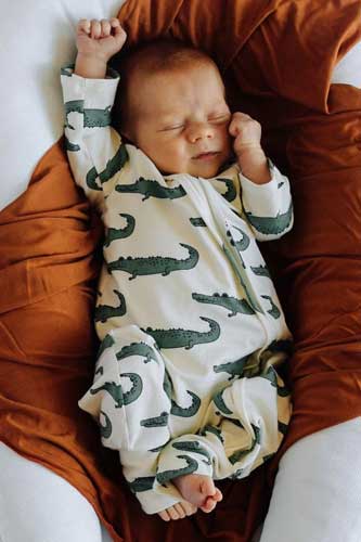 baby wearing brightnTiny organic sleeper made in USA